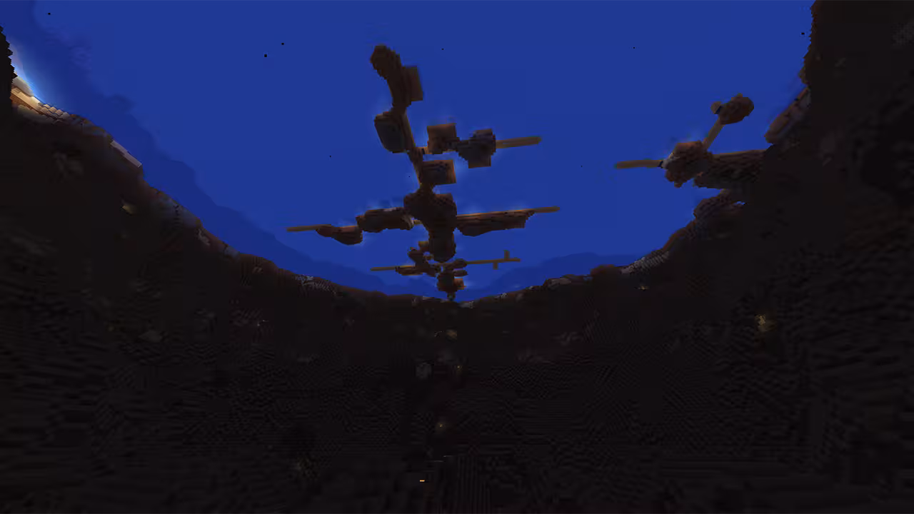 wide Minecraft screenshot taken from the bottom of a massive, dark crater