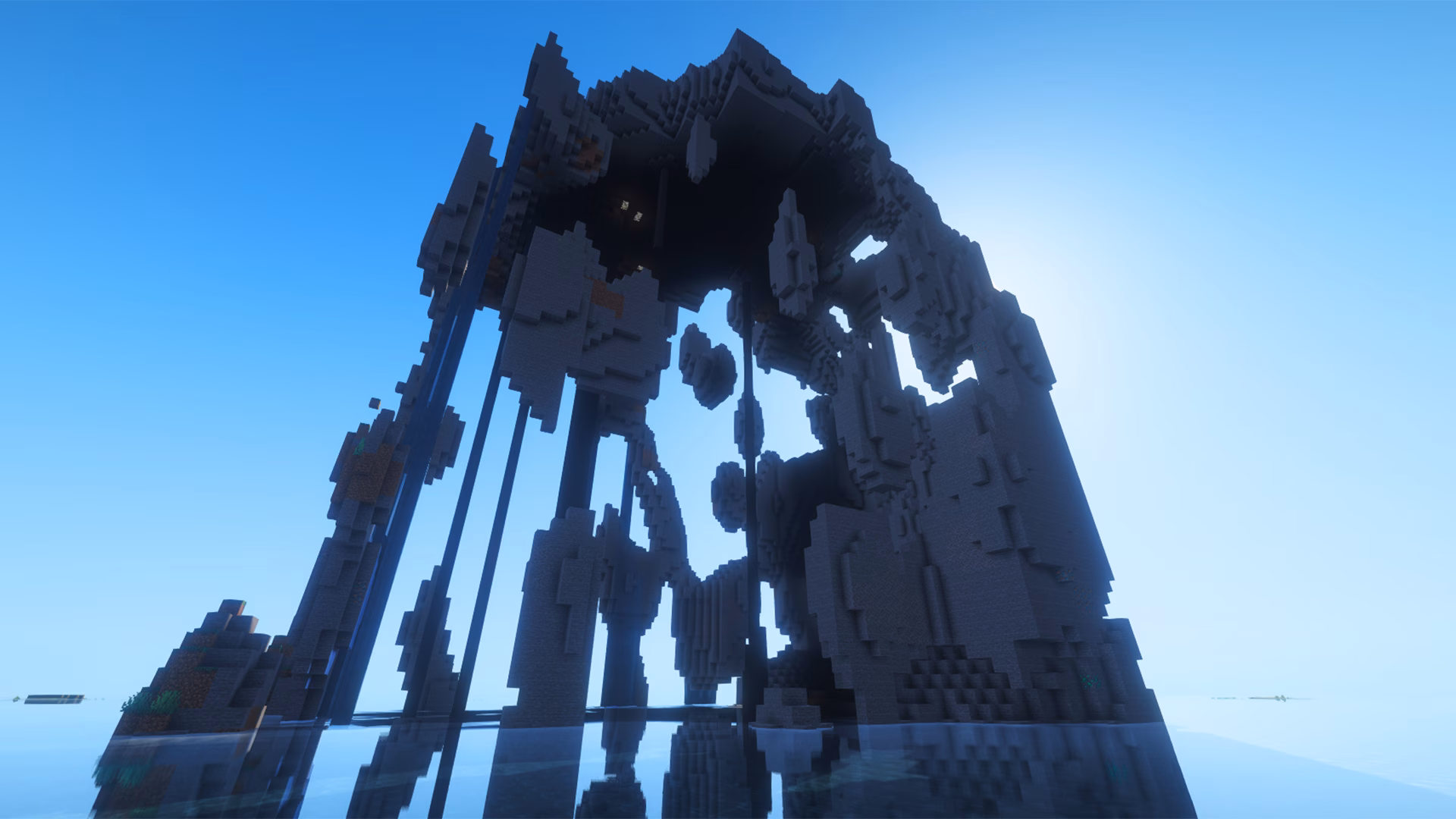 close up view of Minecraft ocean island seed with a giant hollow stone arch rock formation rising from the sea